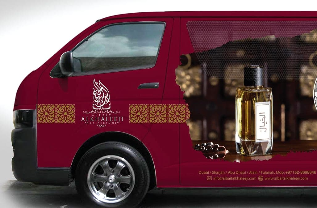 Maroon van wrapped in Al Bait Al Khaleeji perfume branding, with a printed bottle graphic along the side