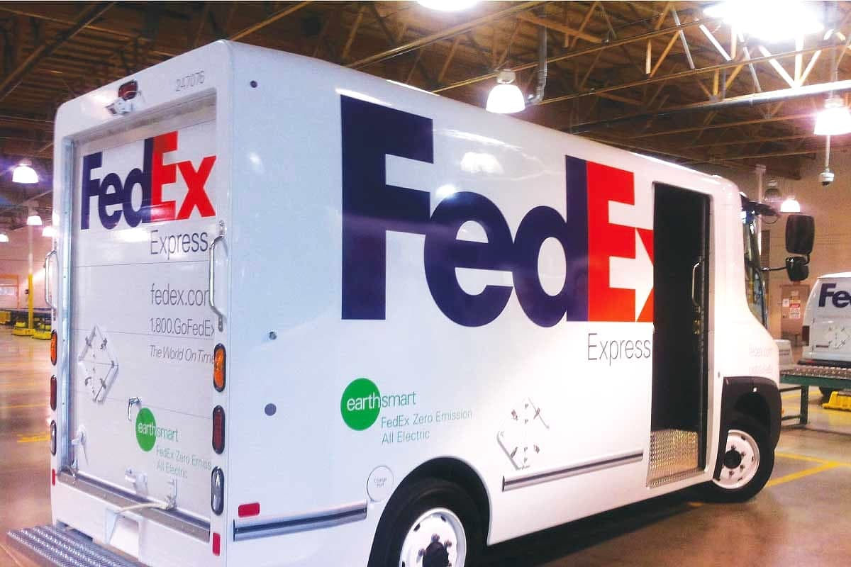 FedEx Express electric delivery truck in full printed livery inside a depot