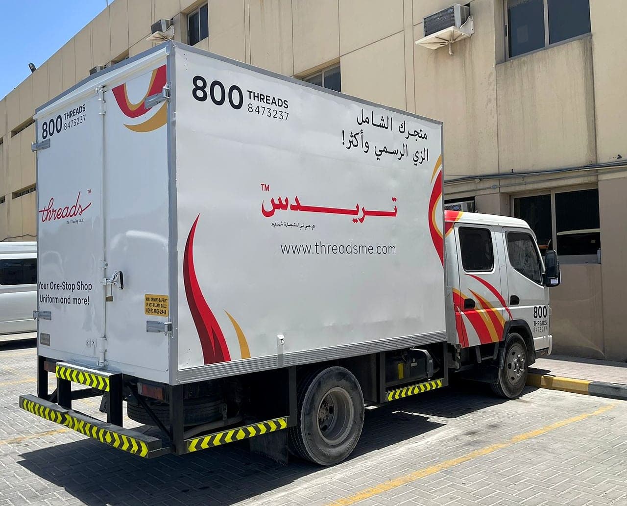 Threads box truck wrapped in red and gold branding